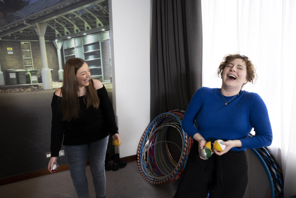 Jenna (left) and Emma (right) holding juggling balls to show off their newly learnt circus skills.
